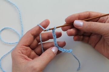 The process of crocheting close-up. Learning to knit. Woman knits.