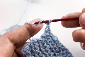The process of crocheting close-up. Learning to knit. Woman knits.