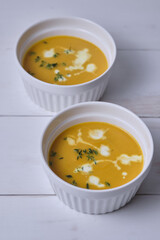Pumpkin cream soup with thyme and cream.