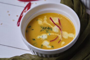 Pumpkin cream soup with thyme and cream.