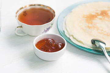 Pancakes, a bouquet with roses, a beautiful vintage breakfast. Sea buckthorn jam. Romantic breakfast for Valentine's Day on February 14 on a white background. Greeting card template. Mother's day card
