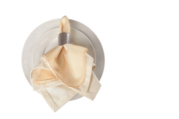 Serving from a napkin and a metal ring on a beige plate. An isolated object. Top view.