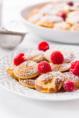 Poffertjes - small Dutch pancakes with fresh raspberries