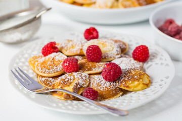 Poffertjes - small Dutch pancakes with fresh raspberries