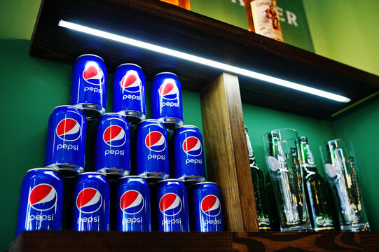 Hai, Ukraine - 08 November, 2017:  Pyramid Made Of Pepsi Cans On The Shelf Along With Carlsberg Beer.