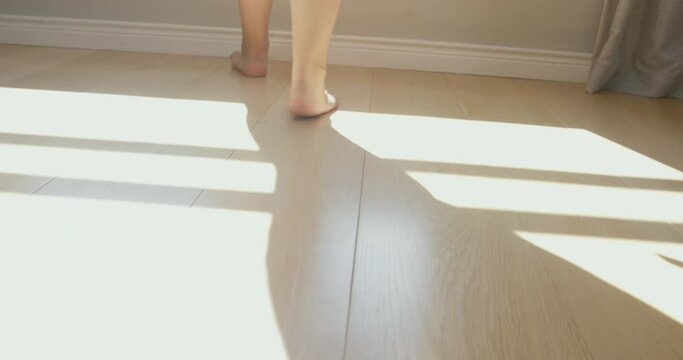 MS TS TU LA Woman walking bare feet in bedroom / Claremont, Cape Town, South Africa