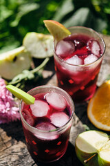 Spanish alcoholic cocktail of wine and fruits. Sangria in glasses with ice and slices of fruit.