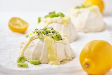 Pavlova cake with cheese cream, lemon Kurd, kiwi and pear.
