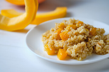 Risotto with pumpkin close-up. Italian dish on a white table.
