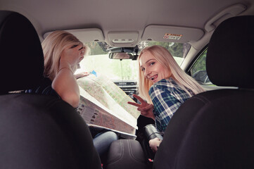 Two girls stopped on the road to get directions