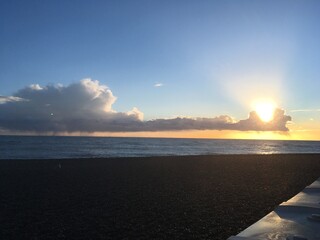 Beach with long cloud and a sunset