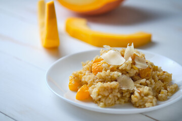 Risotto with pumpkin close-up. Italian dish on a white table.