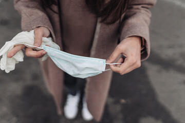 Woman puts on a protective medical mask.