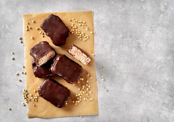 Vegan green buckwheat healthy bars with dark chocolate icing