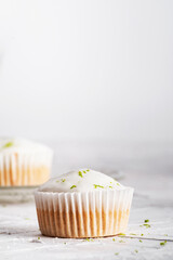 Sweet lemon muffins with zest and icing sugar. Vertical background. Close up.