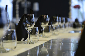 Decoration of wedding tables wine glasses and flowers.