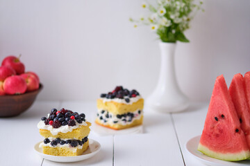 Sponge cake with fresh berries and curd cream for lovers. Summer romantic dessert. Surprise for the beloved.