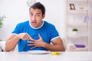 Young hungry man in dieting concept