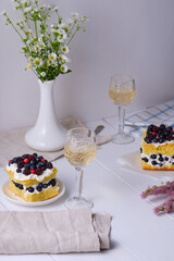 Sponge cake with fresh berries and curd cream for lovers. Summer romantic dessert. Surprise for the beloved.