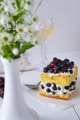 Sponge cake with fresh berries and curd cream for lovers. Summer romantic dessert. Surprise for the beloved.