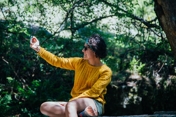 mujer en el monte con telefono y auriculares