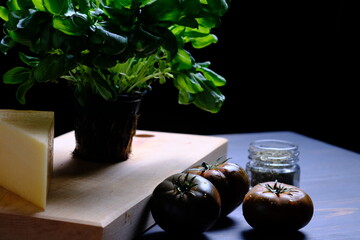 The process of making pizza. Pizza products. Cheese, basil, oregano, tomato.