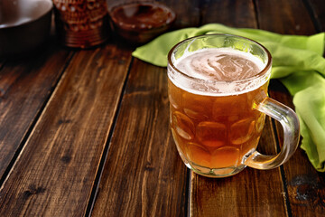Mug of beer on dark rustic background