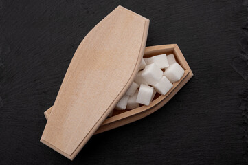 Diabetes disease, insulin resistance and added sugars are killing you concept with coffin filled...