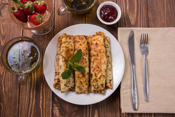 fried pancakes and strawberries closeup on a wooden table. Dessert. Healthy breakfast. Proper nutrition