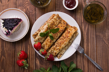 fried pancakes and strawberries closeup on a wooden table. Dessert. Healthy breakfast. Proper nutrition