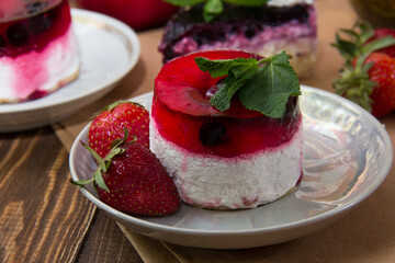 dessert with strawberries close-up on a decorative background. Strawberry jelly. 
Delicate Strawberry Cheesecake On A White Plate