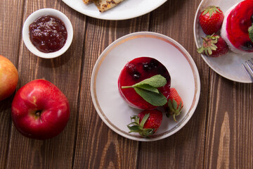 dessert with strawberries close-up on a decorative background. Strawberry jelly. 
Delicate Strawberry Cheesecake On A White Plate