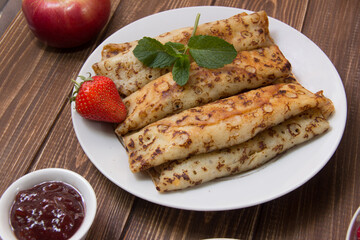 fried pancakes and strawberries closeup on a wooden table. Dessert. Healthy breakfast. Proper nutrition