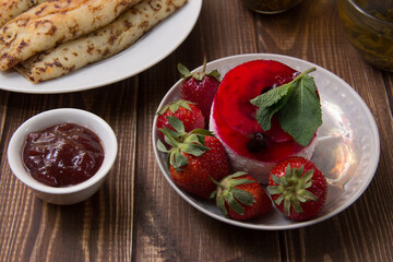 dessert with strawberries close-up on a decorative background. Strawberry jelly. 
Delicate Strawberry Cheesecake On A White Plate