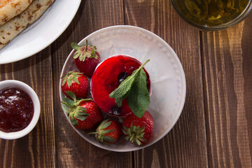 dessert with strawberries close-up on a decorative background. Strawberry jelly. 
Delicate Strawberry Cheesecake On A White Plate