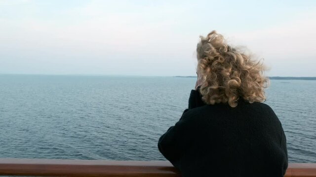 Teenage girl traveling on ferry connecting island with mainland