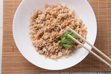Rice with soy sauce and boiled vegetables close-up on a decorative background. Rice Dish. Fried...