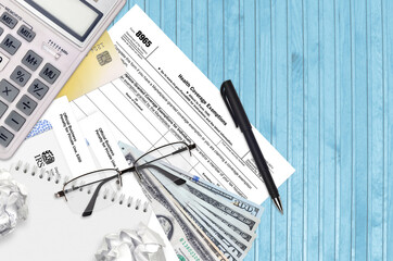 IRS form 8965 Health Coverage Exemptions lies on flat lay office table and ready to fill. U.S....