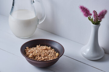 Muesli in a plate for breakfast on a white table.