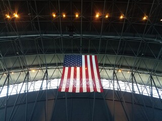 large United States flag hanging from the rafters