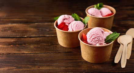 Strawberry ice cream in recycled craft paper cups
