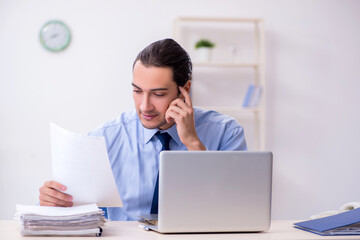 Young male employee in the office