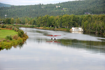Sea plane takes off and lands on the Chena River near Fairbanks, Alaska.