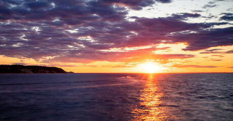 Boat in the red sunset horizon