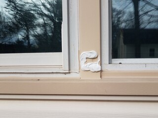 filled or repaired hole in damaged metal frame of window on house