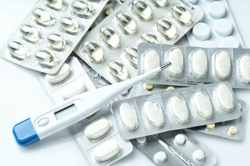 Medical digital thermometer and medical mask and pills. Medical concept