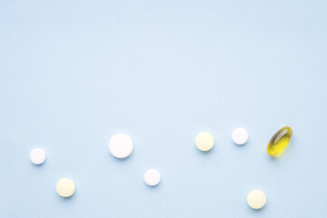 Pills on blue background. Copy space, top view