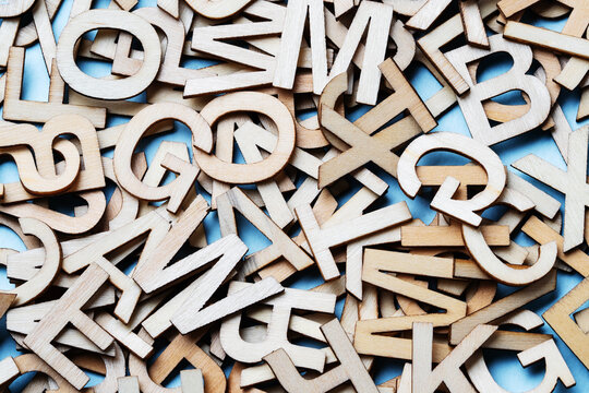 Mixed wooden letters close-up on a blue background