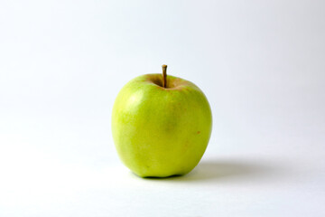 Big green apple close-up on a white background.