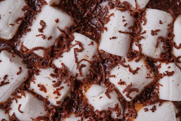 Marshmallows with chocolate close-up. Hot chocolate. Background. Top view.